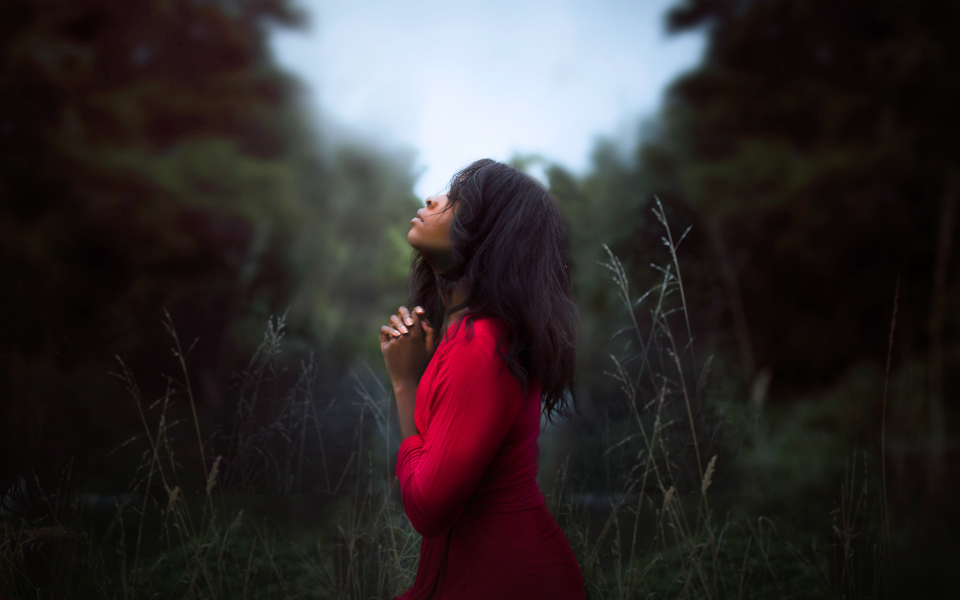 woman praying in the wilderness